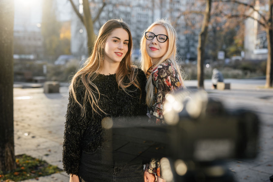 two young females in front of video camera