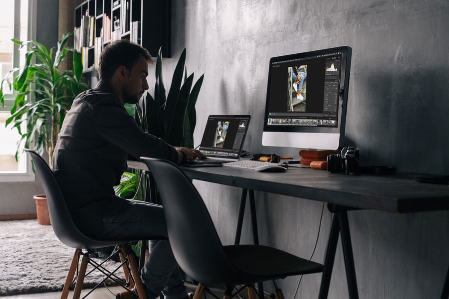Man working from home and sitting with computer in front of him.